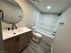 Bright bathroom features a modern vanity, toilet, and tub/shower combo at 5720 Goldmount Ave, Las Vegas, NV 89107