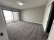 Carpeted bedroom with patio access and closet at 5720 Goldmount Ave, Las Vegas, NV 89107