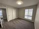 Bedroom featuring carpeted floor, a sliding-door closet, and a window with blinds at 5720 Goldmount Ave, Las Vegas, NV 89107