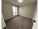 Well-lit bedroom featuring a carpeted floor and a window with blinds at 5720 Goldmount Ave, Las Vegas, NV 89107