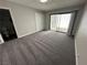 Spacious bedroom with carpeted floors, closet, and sliding door to patio at 5720 Goldmount Ave, Las Vegas, NV 89107