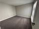 Bedroom featuring a carpeted floor, light gray walls, and a window with blinds at 5720 Goldmount Ave, Las Vegas, NV 89107
