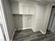 Efficient laundry room with overhead cabinets and gray wood-look flooring at 5720 Goldmount Ave, Las Vegas, NV 89107