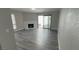 Bright living room with modern flooring, fireplace, sliding glass door, and fresh paint at 5720 Goldmount Ave, Las Vegas, NV 89107