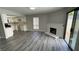 Bright living room featuring wood flooring, a fireplace, and sliding glass doors to the backyard at 5720 Goldmount Ave, Las Vegas, NV 89107