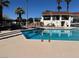 Community swimming pool with sun loungers and a clubhouse in the background at 5720 Goldmount Ave, Las Vegas, NV 89107