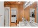 Bathroom with wood plank wall, tile shower, and view to the bedroom at 59 Desert Dawn Ln, Henderson, NV 89074