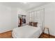 Cozy bedroom with wooden floors, closet, and shuttered window allowing natural light at 59 Desert Dawn Ln, Henderson, NV 89074