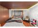 Bedroom featuring wood ceiling, textured wall, window, and plush bedding at 59 Desert Dawn Ln, Henderson, NV 89074