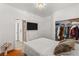 Neutral bedroom featuring a closet, wood floors, and adjacent bathroom for convenience at 59 Desert Dawn Ln, Henderson, NV 89074