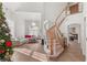 Bright foyer with tile flooring, curved staircase, and views to the living room at 59 Desert Dawn Ln, Henderson, NV 89074