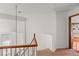 Upper hallway featuring neutral walls, wood trim, and a view of the bedroom at 59 Desert Dawn Ln, Henderson, NV 89074