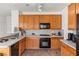 A beautiful kitchen featuring stainless steel appliances, tile flooring, and light wood cabinets at 59 Desert Dawn Ln, Henderson, NV 89074