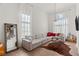 Bright living room with tall ceilings, tile flooring, and large windows at 59 Desert Dawn Ln, Henderson, NV 89074