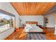 A well lit main bedroom featuring wood ceiling, textured walls, and large window at 59 Desert Dawn Ln, Henderson, NV 89074