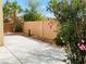Backyard showcasing a concrete patio, desert landscaping, and a privacy wall at 6245 Blushing Willow St, North Las Vegas, NV 89081
