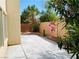 Private backyard with a concrete patio, mature landscaping, and a serene outdoor space at 6245 Blushing Willow St, North Las Vegas, NV 89081
