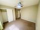 Bedroom featuring a ceiling fan, neutral paint and carpet, and a closet at 6245 Blushing Willow St, North Las Vegas, NV 89081