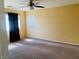 Spacious bedroom featuring a ceiling fan, carpeted floors, and ample natural light at 6245 Blushing Willow St, North Las Vegas, NV 89081