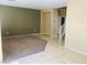 Open-concept living area featuring neutral paint, tile and carpet flooring, and great natural light at 6245 Blushing Willow St, North Las Vegas, NV 89081