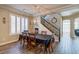 Dining area with plank flooring, stairway, designer chandelier, and shuttered windows at 6403 Brandon Hills Ct, Las Vegas, NV 89139