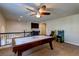 Upstairs game room with an air hockey table, arcade games, and custom cabinets with iron railing at 6403 Brandon Hills Ct, Las Vegas, NV 89139