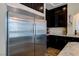 Kitchen featuring a stainless steel refrigerator, granite countertops, and dark wood cabinetry at 6403 Brandon Hills Ct, Las Vegas, NV 89139