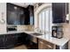 Kitchen with stainless steel sink, granite countertops, dark wood cabinets, and stainless steel dishwasher and microwave at 6403 Brandon Hills Ct, Las Vegas, NV 89139