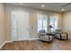 Living area featuring plank floors, shutters on windows, and two patterned accent chairs at 6403 Brandon Hills Ct, Las Vegas, NV 89139