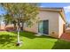 Private backyard with well kept artificial grass and desert landscaping perfect for relaxing or entertaining at 6711 Quarterhorse Ln, Las Vegas, NV 89148