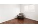 Bedroom with a cozy chair and a large window, complemented by wood flooring at 6711 Quarterhorse Ln, Las Vegas, NV 89148