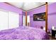 Bedroom featuring hardwood floors, and neutral-toned walls with a TV hanging on the wall at 6711 Quarterhorse Ln, Las Vegas, NV 89148