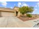 Inviting single-story home with well-maintained front yard, desert landscaping, and a two car garage at 6711 Quarterhorse Ln, Las Vegas, NV 89148