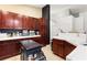 Dark wood cabinets with white countertops in kitchen featuring an island, offering ample storage and functionality at 6711 Quarterhorse Ln, Las Vegas, NV 89148