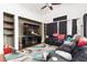 Spacious living room with a large TV, built-in shelving, comfortable seating, and stylish area rug at 6711 Quarterhorse Ln, Las Vegas, NV 89148