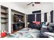 Comfortable living room featuring large TV, built-in shelves, and plush seating, perfect for relaxation and entertainment at 6711 Quarterhorse Ln, Las Vegas, NV 89148