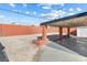 Landscaped backyard featuring a covered patio, gravel, and brick column planters at 704 Slayton Dr, Las Vegas, NV 89107