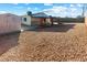 Backyard with gravel landscaping, a covered patio, and a storage shed at 704 Slayton Dr, Las Vegas, NV 89107