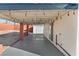 Covered patio with outdoor lighting and gravel landscaping in the backyard at 704 Slayton Dr, Las Vegas, NV 89107
