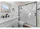 Bathroom with a new shower, modern hardware, and a white vanity at 704 Slayton Dr, Las Vegas, NV 89107