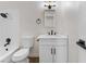 Modern bathroom featuring black hardware, a shower with detachable head, and white cabinets at 704 Slayton Dr, Las Vegas, NV 89107