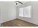 Comfortable bedroom featuring vinyl floors, a ceiling fan, and a large window at 704 Slayton Dr, Las Vegas, NV 89107