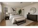 Staged bedroom featuring a warm color palette, large bed, and decorative furnishings at 704 Slayton Dr, Las Vegas, NV 89107