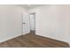 Bright bedroom featuring wood floors and a white door leading to another room at 704 Slayton Dr, Las Vegas, NV 89107