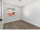 Well-lit bedroom with vinyl flooring and a window showcasing the backyard at 704 Slayton Dr, Las Vegas, NV 89107