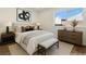 Virtually staged bedroom showcasing stylish furniture, a comfortable bed and a window at 704 Slayton Dr, Las Vegas, NV 89107
