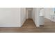 Hallway provides view of wood flooring and leads to kitchen at 704 Slayton Dr, Las Vegas, NV 89107