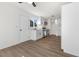 Updated kitchen offers stainless steel appliances, white cabinets, and wood flooring at 704 Slayton Dr, Las Vegas, NV 89107