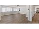 Open-concept living room featuring wood-look floors, neutral walls, and bright natural light at 704 Slayton Dr, Las Vegas, NV 89107