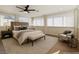 Bedroom features neutral colors, ceiling fan, and updated lighting at 704 Slayton Dr, Las Vegas, NV 89107